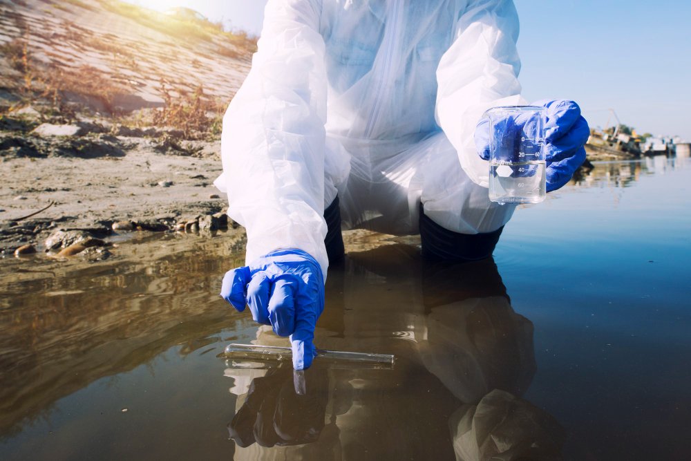 Scientist collecting water sample for lab testing