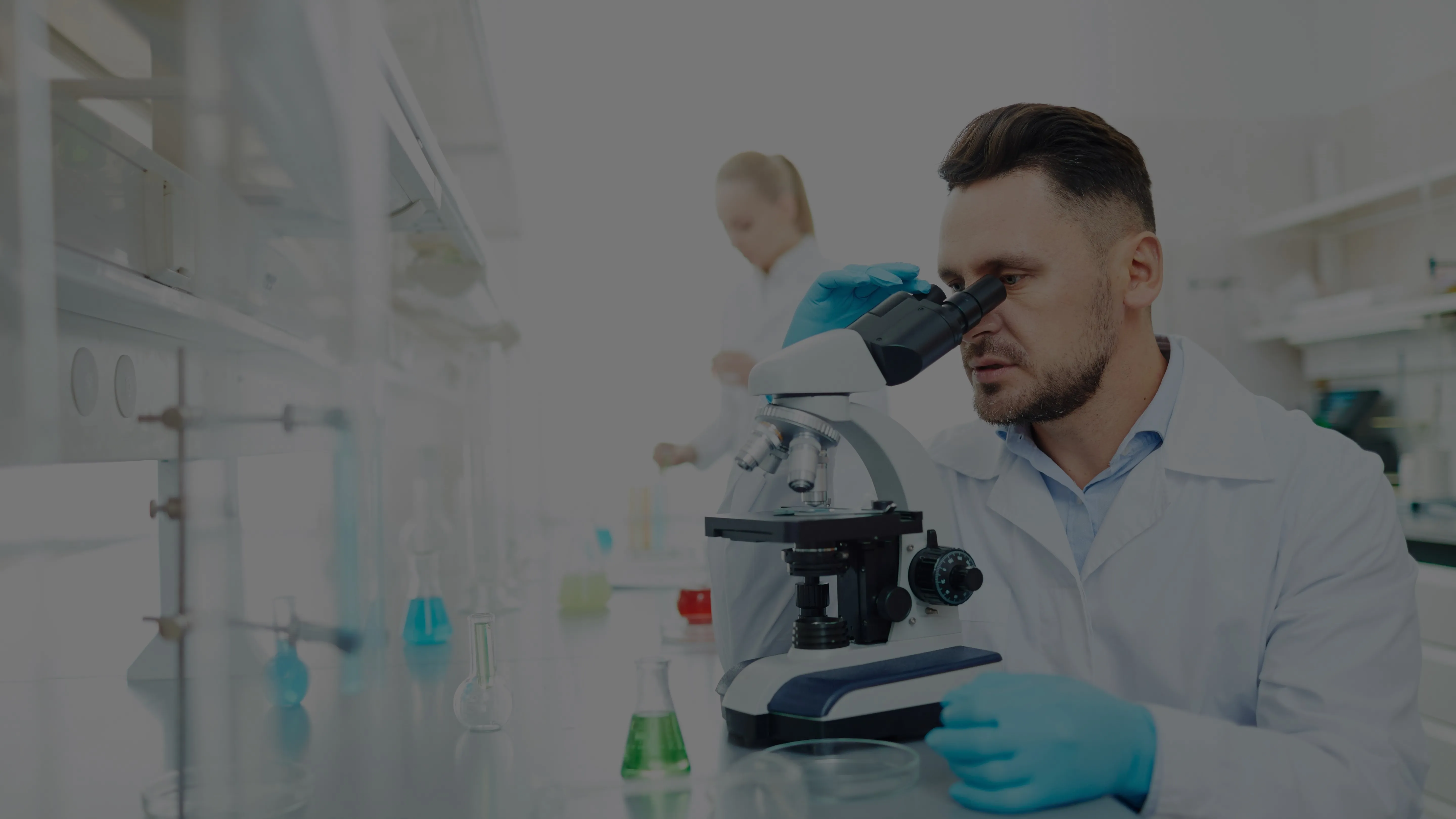 chemist looking into microscope