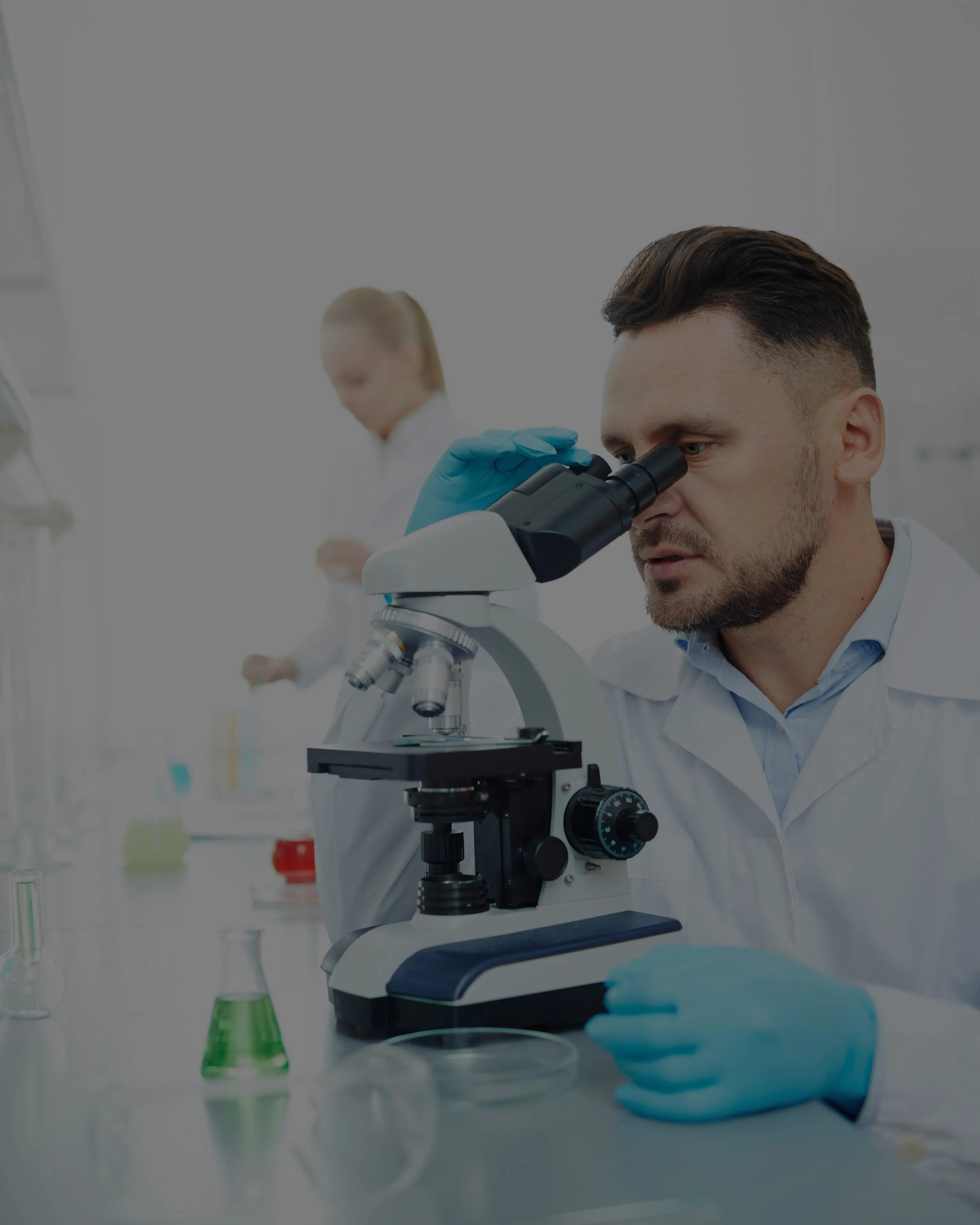 chemist looking into microscope