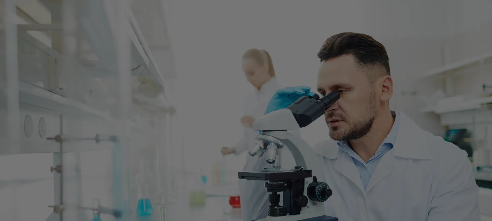 chemist looking into microscope