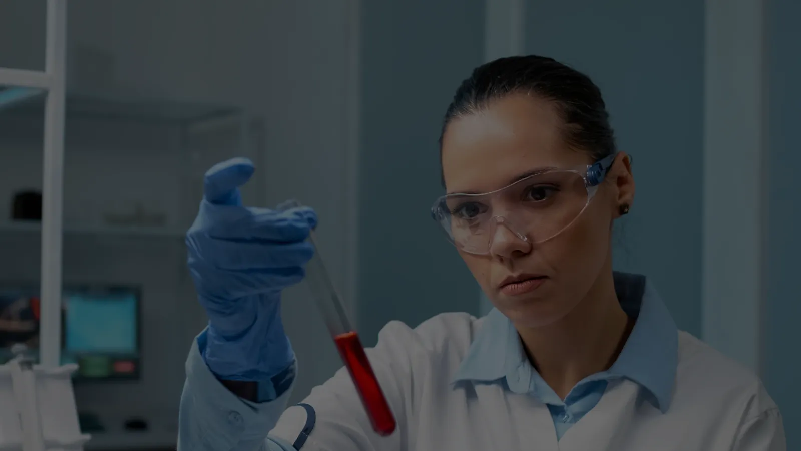 chemist looking at test tube
