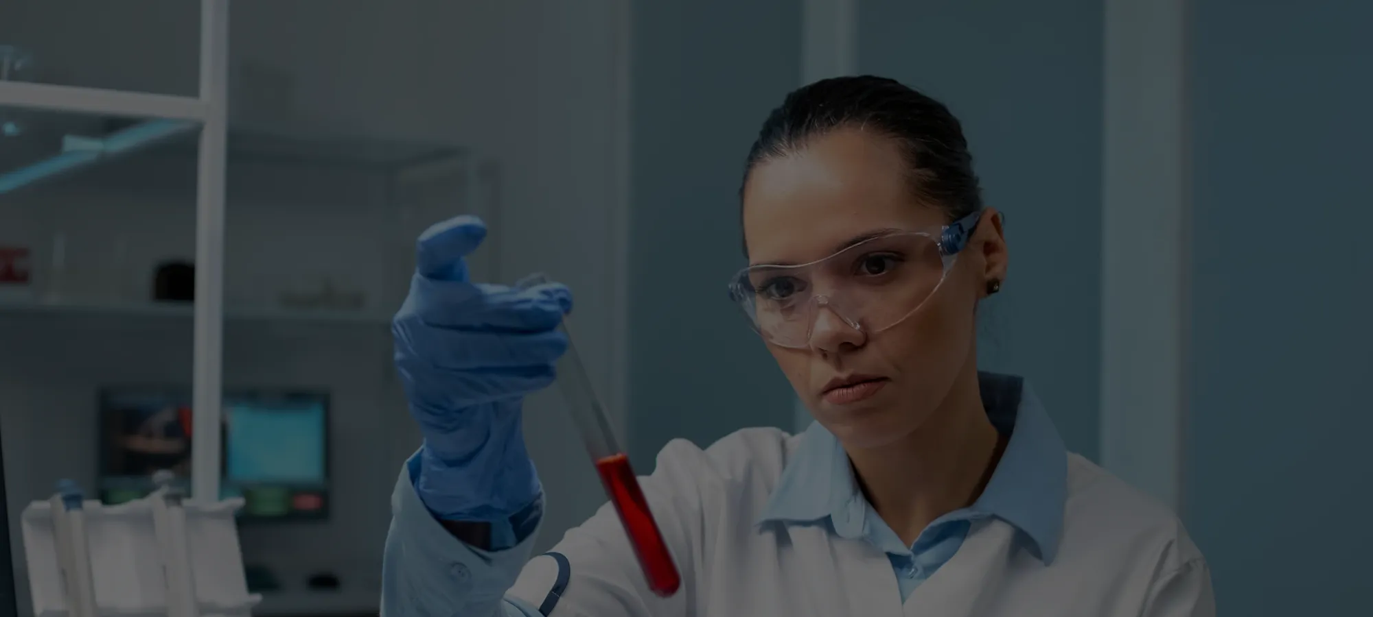 chemist looking at test tube