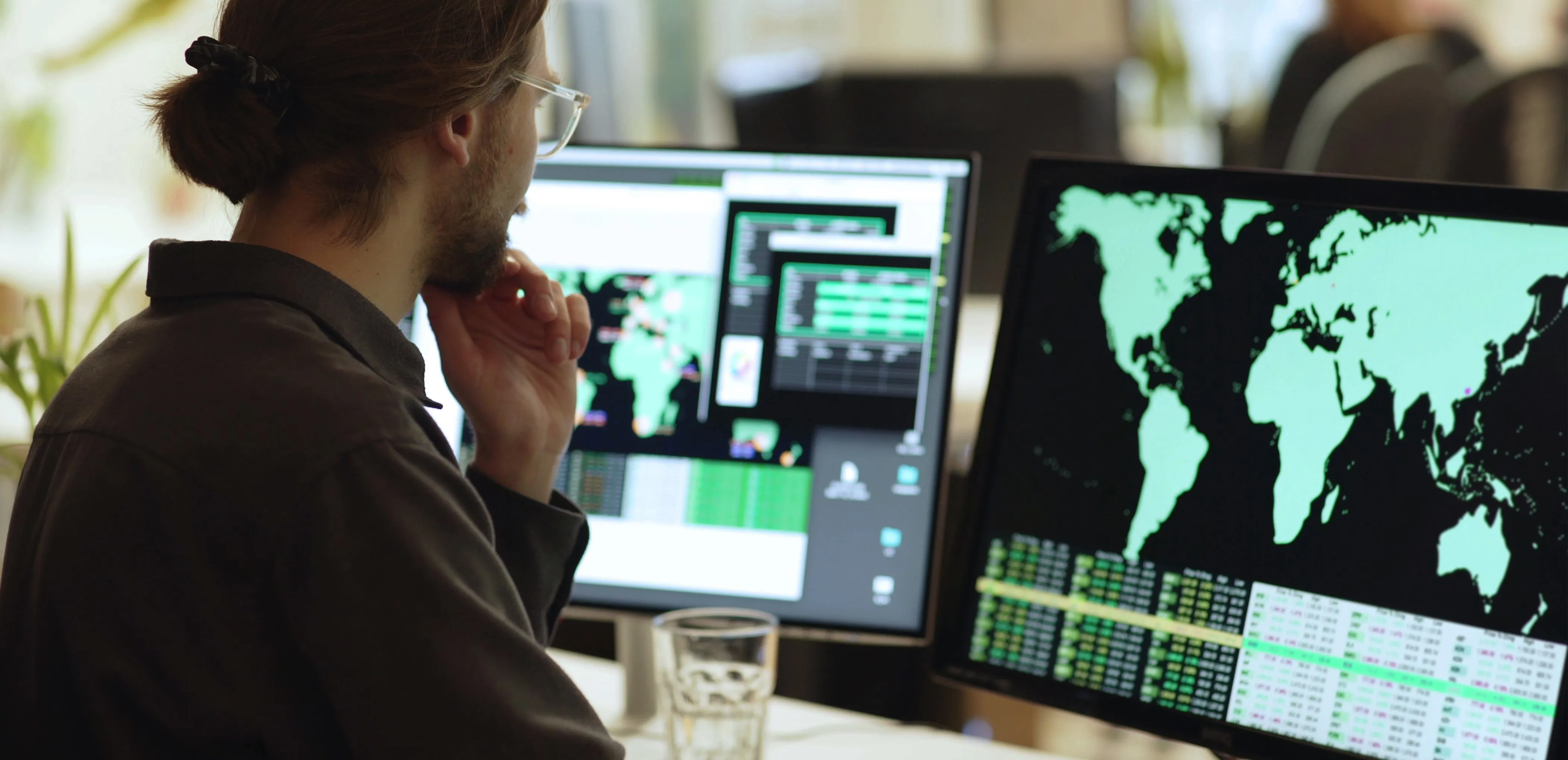 person looking at world map on computers