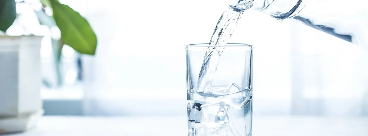 hand holding full glass of water