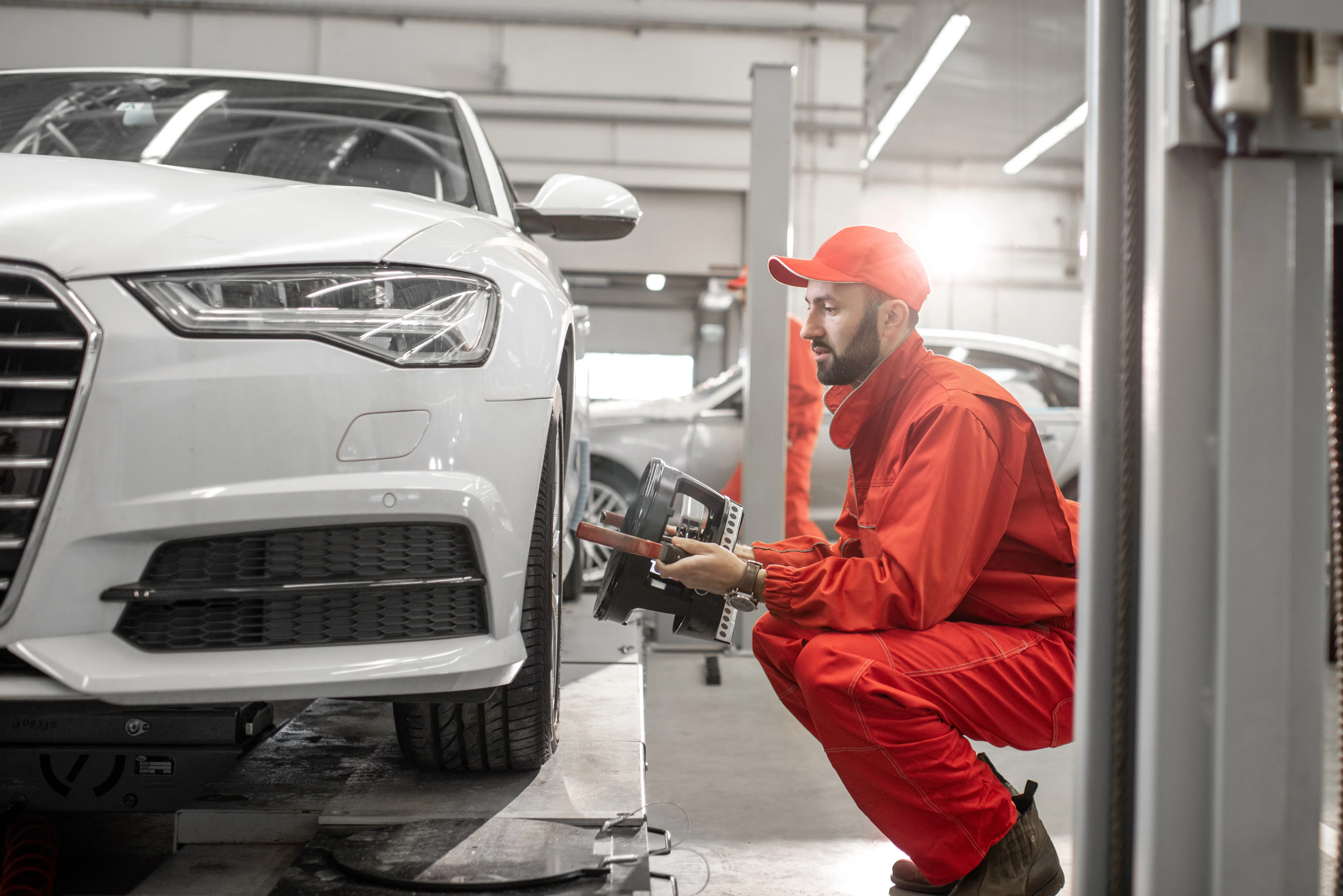 man examining car wheel