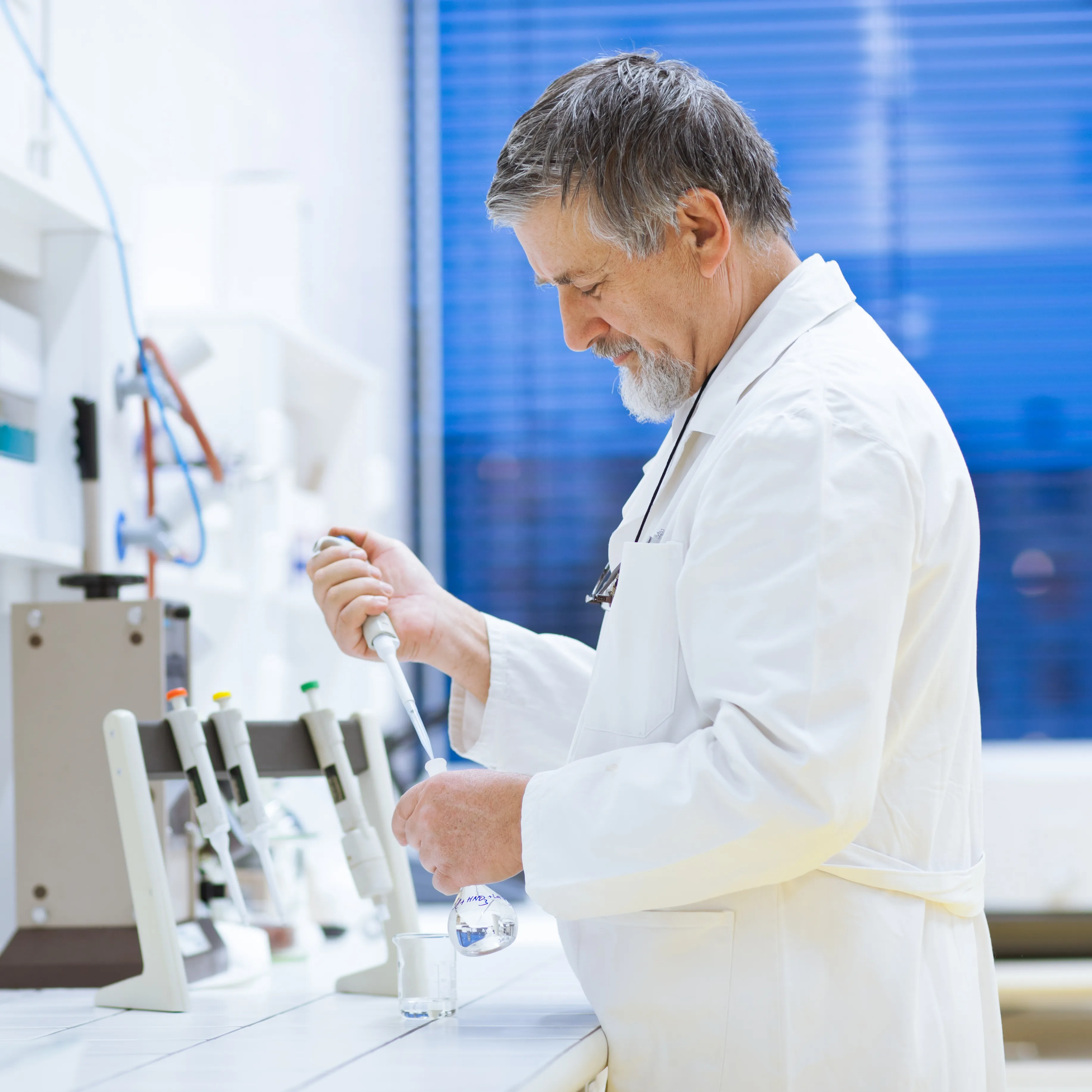 scientist using dropper in laboratory