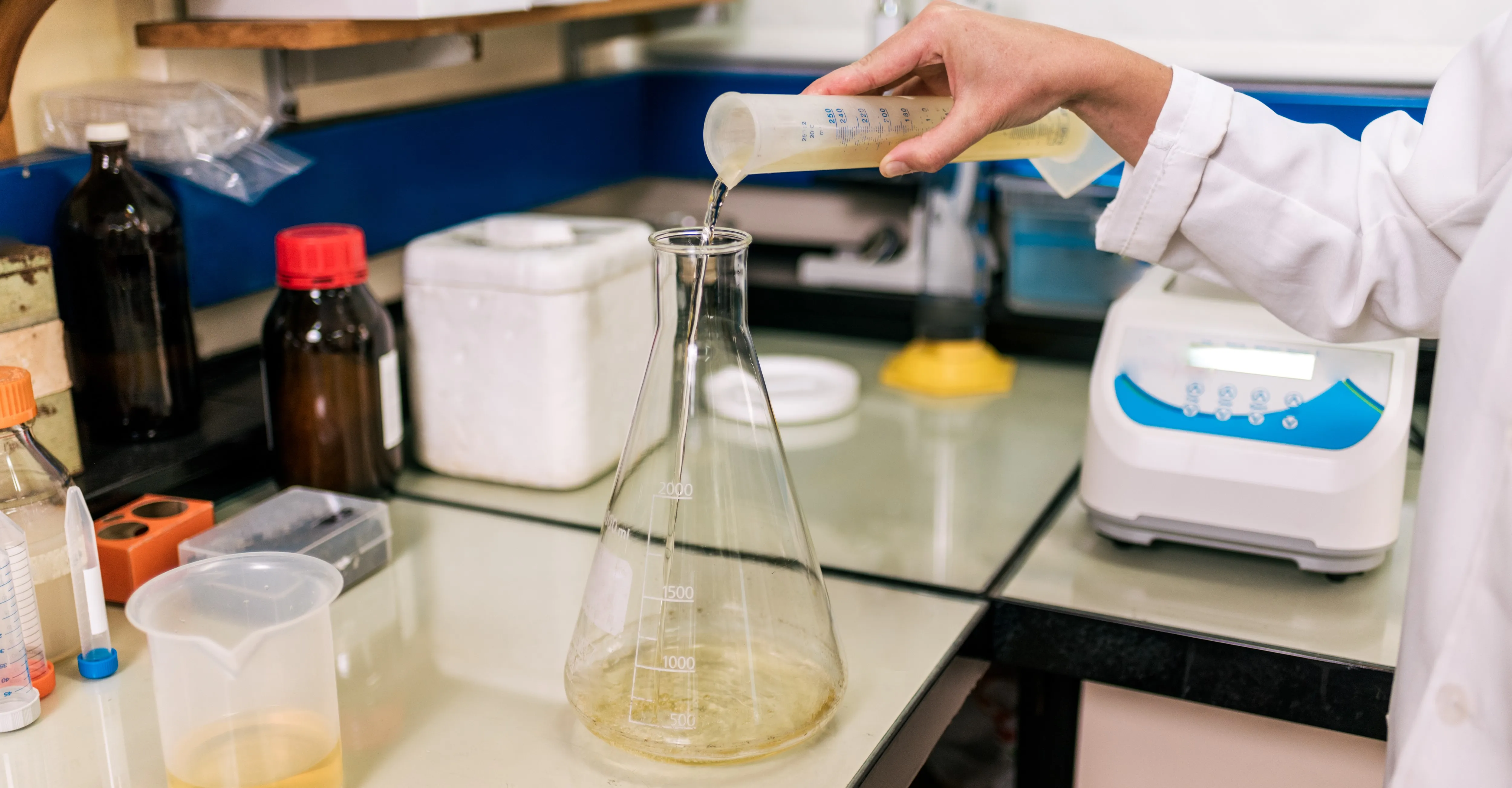 pouring wastewater into beaker